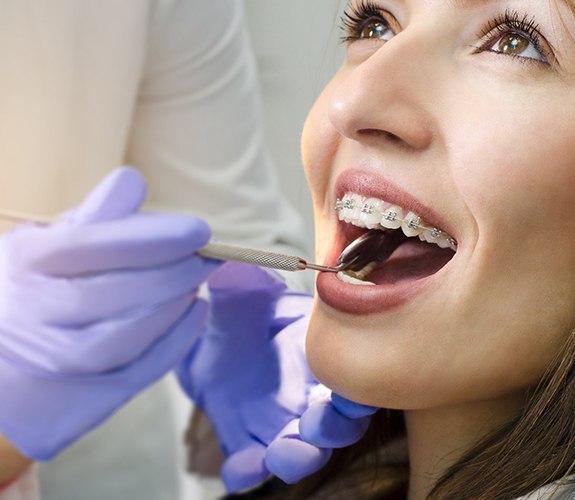 Woman with braces visiting her South Elgin orthodontist for checkup