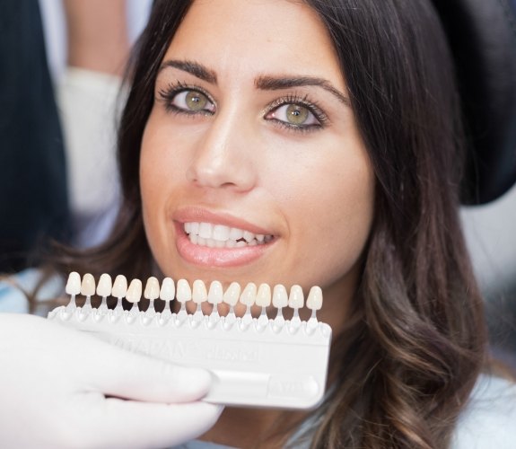 Woman receiving dental veneers from her cosmetic dentist in South Elgin