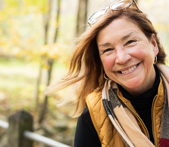 Older woman smiling confidently with dentures