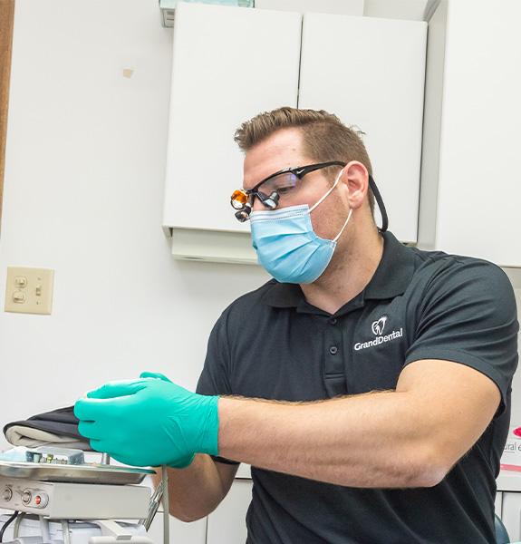 Man in dental chair smiling at dentist