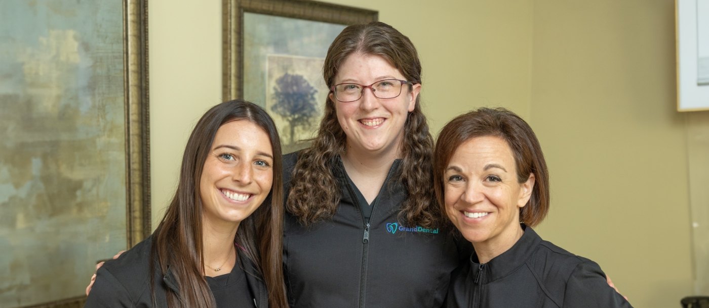 Three smiling dental hygienists
