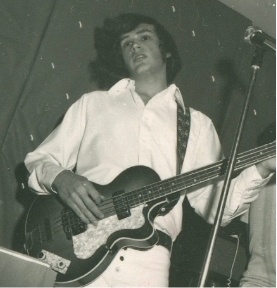 Young Doctor Siewert playing bass guitar
