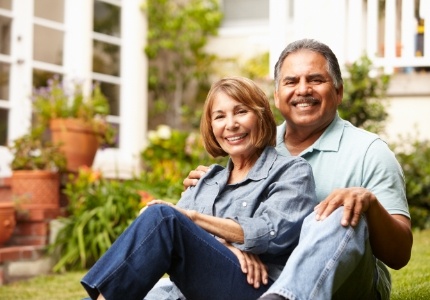 Man and woman smiling together on outdoor bench