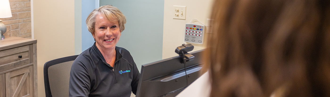 Three smiling dental team members at Grand Dental South Elgin