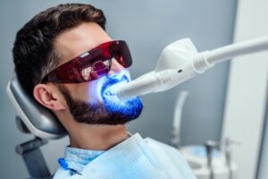 a man having his teeth whitened at the dentist