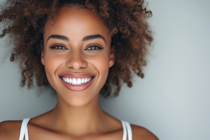 a woman smiling after teeth whitening